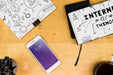 Free Smartphone Mockup With Office Materials On Table Psd