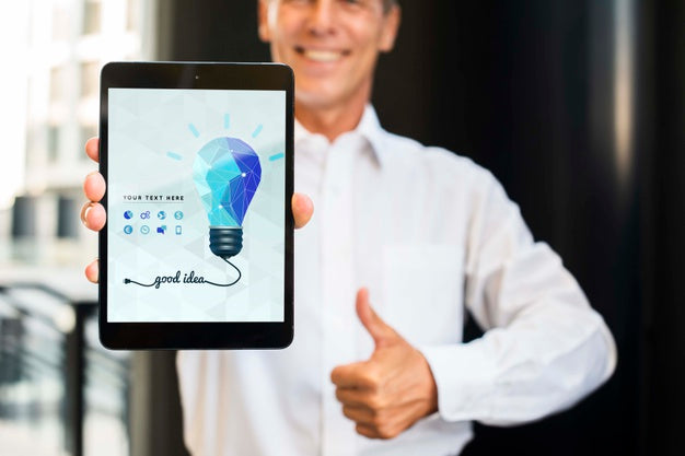 Free Smiley Businessman Outdoors Holding Vertical Digital Tablet Psd