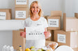 Free Smiley Female Volunteer Holding Blank Paper Next To Food Box Psd