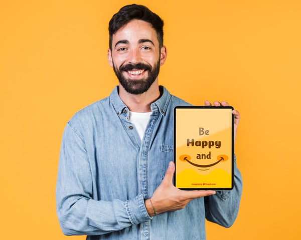 Free Smiling Young Man Holding Tablet Mock Up Psd