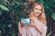 Free Spring Concept With Woman Holding Smartphone Mockup Psd