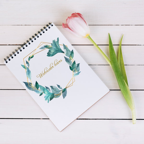 Free Spring Notebook Mockup With Decorative Plant In Top View Psd