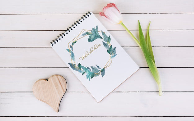 Free Spring Notebook Mockup With Decorative Plant In Top View Psd