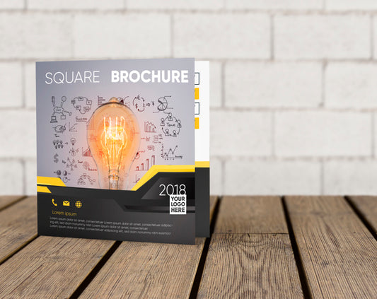 Free Square Brochure Mockup On Wooden Surface Psd