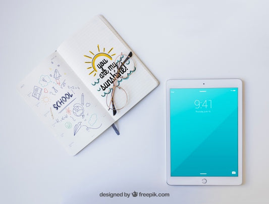 Free Tablet, Glasses And Notebook With Drawings Psd