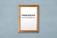 Free Thin Wooden Frame Over Blue Wall Mockup Psd