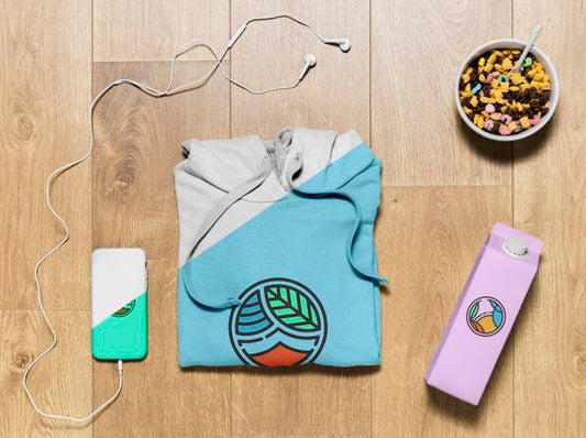 Free Top View Folded Hoodie Mock-Up With Phone Case, Bottle And Snack Psd