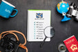 Free Top View Of Checklist With Magnifying Glass And Camera For Traveling Psd