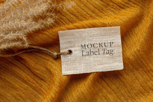 Free Top View Of Clothing Label Mock-Up On Orange Textile Psd