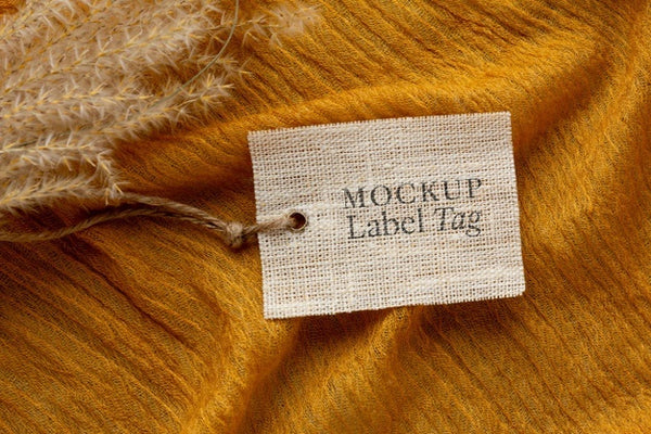Free Top View Of Clothing Label Mock-Up On Orange Textile Psd