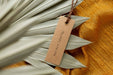 Free Top View Of Clothing Label Mock-Up On Orange Textile With Leaves Psd