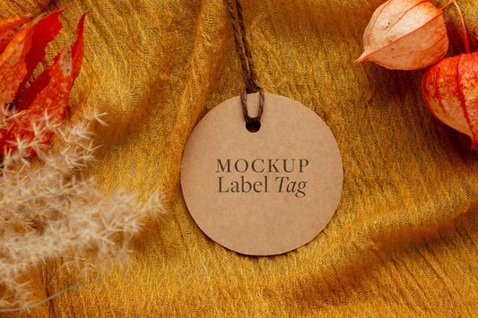 Free Top View Of Clothing Label On Orange Textile With Flowers Psd