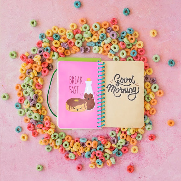 Free Top View Of Colorful Cereals And Notebook On Plain Background Psd