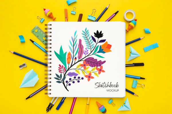 Free Top View Of Desk Surface With Notebook And Colorful Pens Psd