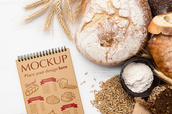 Free Top View Of Notebook With Bread And Wheat Psd