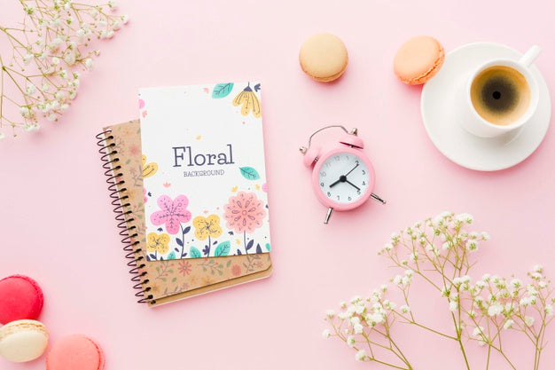 Free Top View Of Notebook With Clock And Macarons Psd