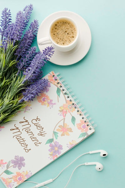 Free Top View Of Notebook With Coffee And Spring Flowers Psd
