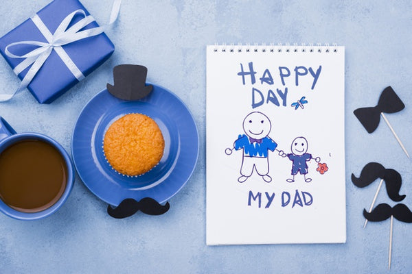 Free Top View Of Notepad With Gift And Cupcake For Fathers Day Psd