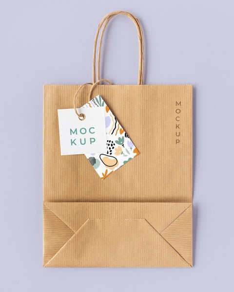 Free Top View Of Paper Shopping Bag Mock-Up With Paper Tag Psd