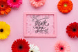 Free Top View Of Pink Frame Mock-Up With Flowers Psd