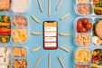 Free Top View Of Smartphone With Planned Meals Psd