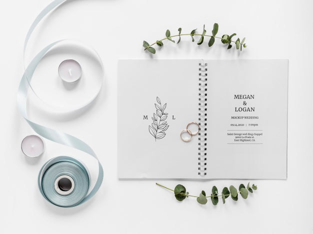 Free Top View Of Wedding Notebook With Ribbon And Rings Psd
