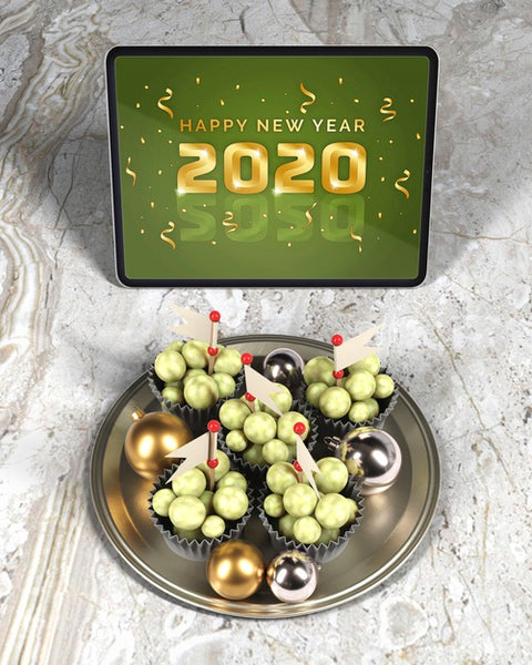 Free Tray With Chocolate Beside Tablet With New Year Message Psd