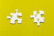 Free Two Puzzle Pieces On Yellow Background Psd