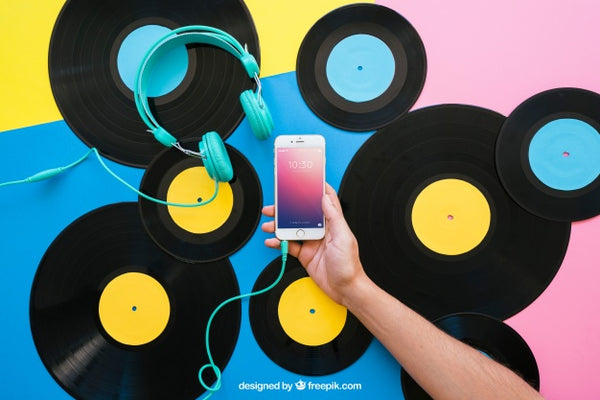 Free Vinyl Mockup With Hand Holding Smartphone Psd