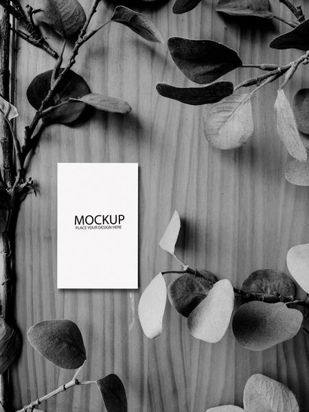 Free White Card Mockup On Black And White Wooden Table Psd