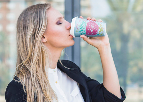 Free Woman Drinking Coffee From Plastic Cup Psd