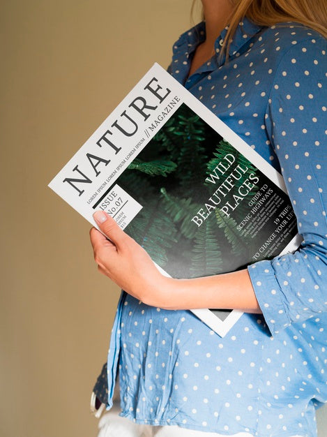Free Woman Holding A Nature Magazine Close To Her Chest Psd