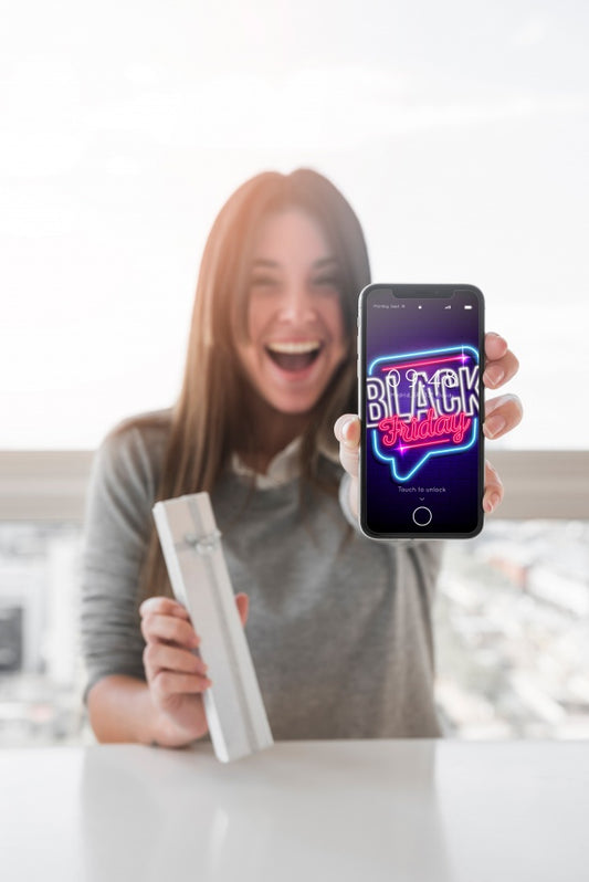 Free Woman Holding Smartphone Mockup With Black Friday Concept Psd