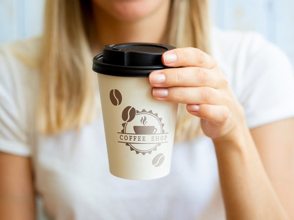 Free Woman Holding Up A Coffee Paper Cup Psd