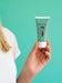 Free Woman Holding Up A Hand Cream Bottle Psd