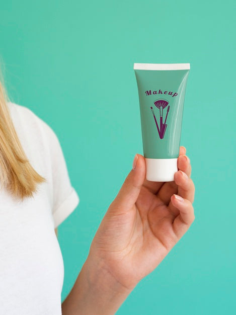 Free Woman Holding Up A Hand Cream Bottle Psd