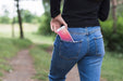 Free Woman In Nature With Smartphone In Pocket Psd