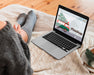 Free Woman Looking At A Laptop With Mock-Up Screen Psd