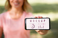 Free Woman Showing A Phone With A Mock-Up Screen Outdoors Psd