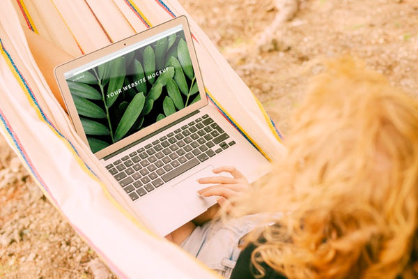 Free Woman Using Laptop Mockup In Nature Psd