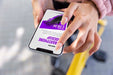 Free Woman Using Mock-Up Smartphone Outdoors While On Bicycle Psd