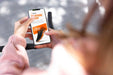 Free Woman Using Mock-Up Smartphone Outdoors While On Bicycle Psd