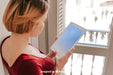 Free Woman Using Tablet In Front Of Window Psd