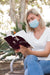 Free Woman Wearing Mask On Street Reading Book Psd