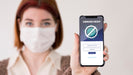 Free Woman With Masks Holding Smartphone Psd