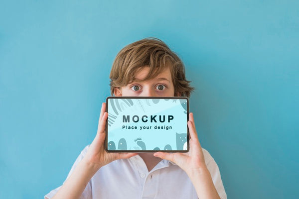 Free Young Boy Holding Phone With Mock-Up Psd