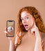 Free Young Woman Holding A Smartphone Mock-Up Psd